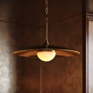 Turin alabaster pendant in unlacquered brass in a dark lacquered dining room