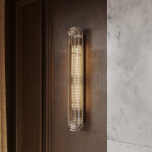 Florian 36" glass wall sconce in polished nickel on a dark wood wall beside marble