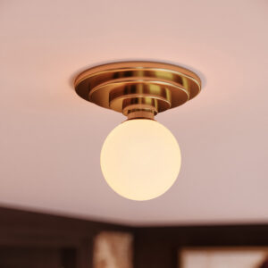 Parisian milk glass semi-flush mount in unlacquered brass on a blush pink ceiling