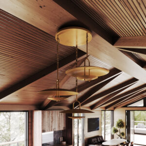 Trousdale multi pendant close up in unlacquered brass in a double-height living room with a vaulted wood ceiling