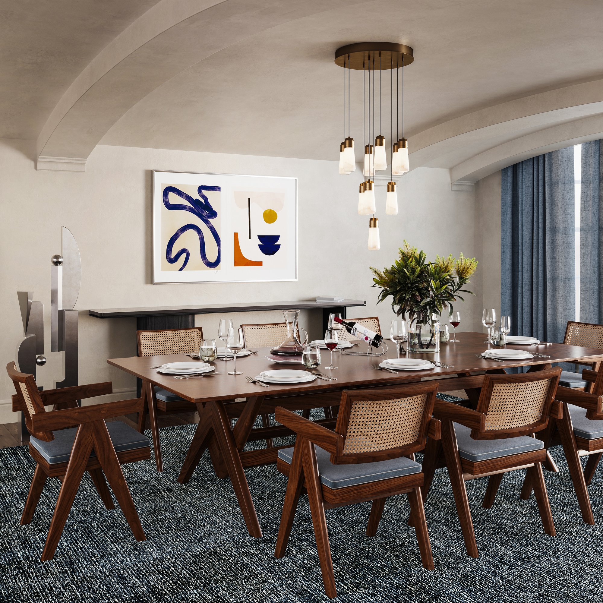 Milano 18" alabaster chandelier in plated brass over a long dining table with cane chairs