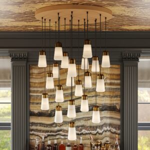 Milano 30" alabaster chandelier in plated brass in front of an onyx wall
