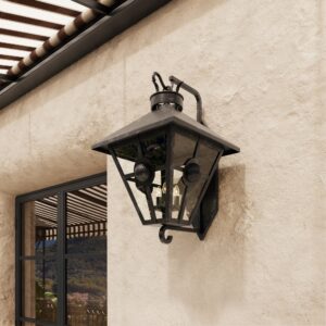 Tuscany outdoor wall lantern in dark bronze on a stucco wall under a striped awning