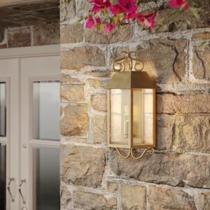 Madrid seeded glass outdoor wall lantern on a stone wall beside a door with bougainvillea