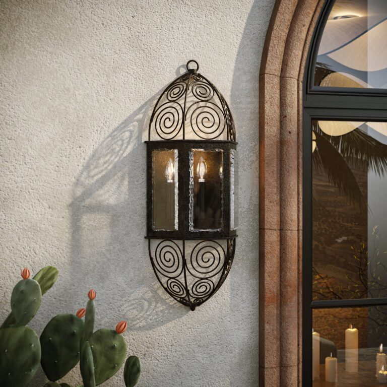 Andalusia iron scrollwork outdoor wall light in aged iron on a stucco wall beside an arched window
